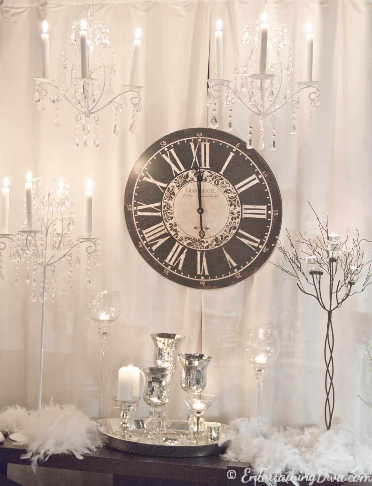 A clock surrounded by candles for a last minute New Year's Eve party decoration