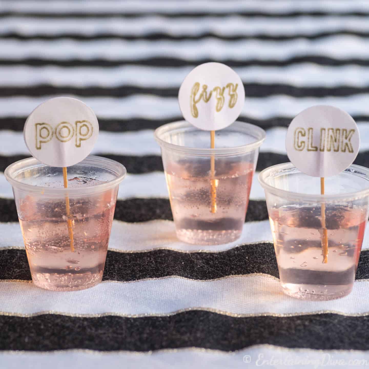 Pink champagne jello shots with pop, fizz, clink toothpicks for a New Year's Eve party