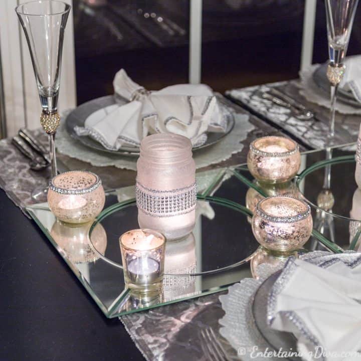 DIY frosted glass mason jar candle on mirror chargers as a last minute New Year's Eve Party decoration on a table