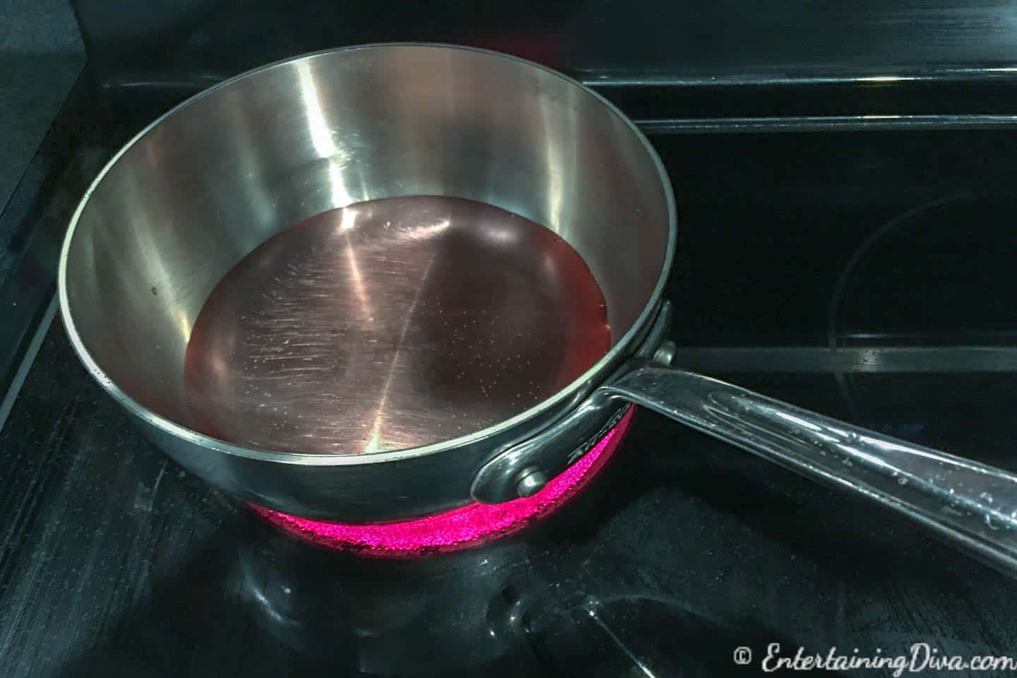 Heating the cranberry juice for pink champagne jelly shots