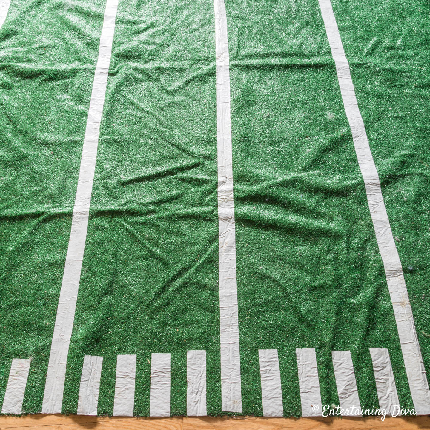 The edge of the football field rug with long and short white tape lines