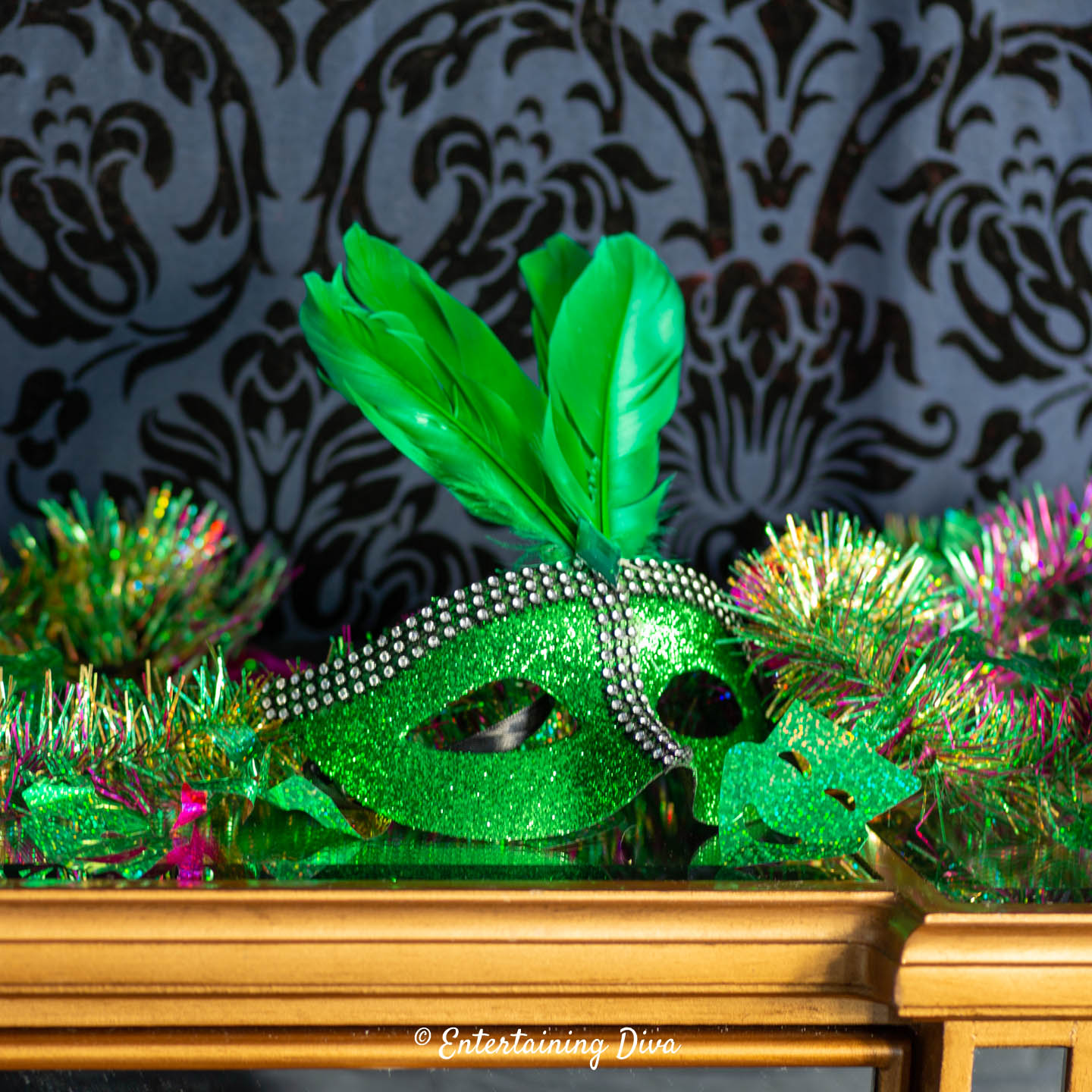 A green mardi gras mask on a table