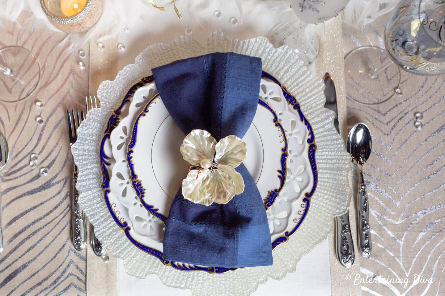 White, blue and gold table setting on winter wonderland tablescape