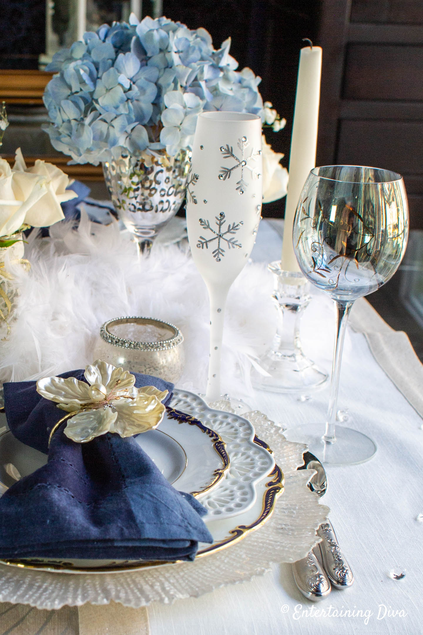 Winter wonderland place setting with snowflake wineglass and blue hydrangeas