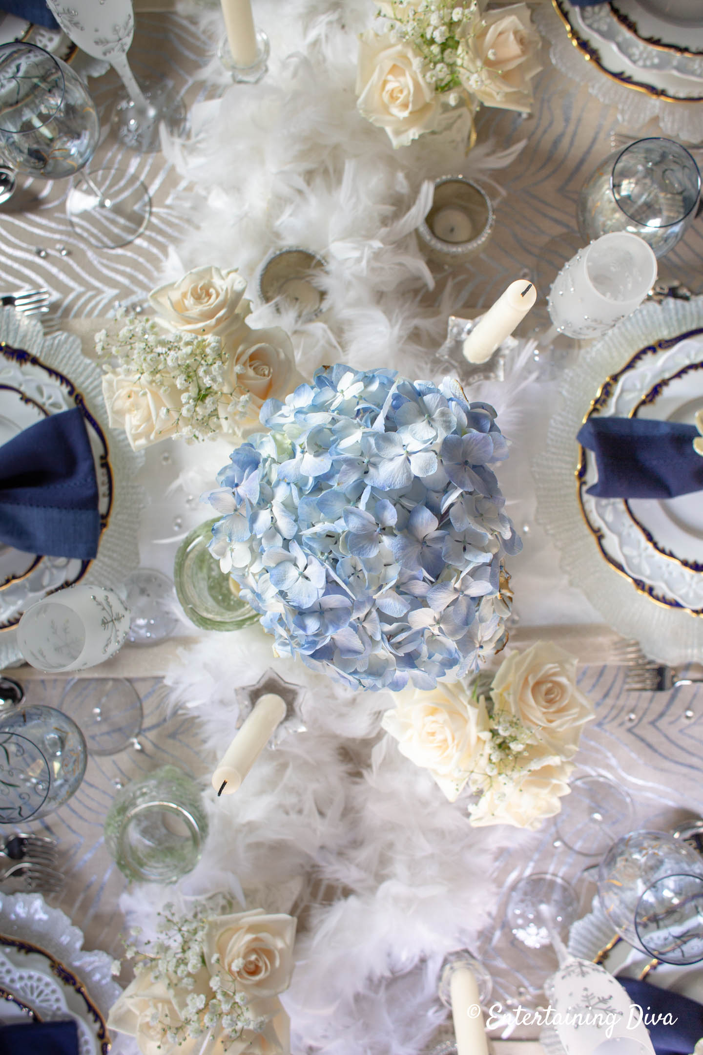 Blue hydrangeas and white roses in a winter wonderland table setting