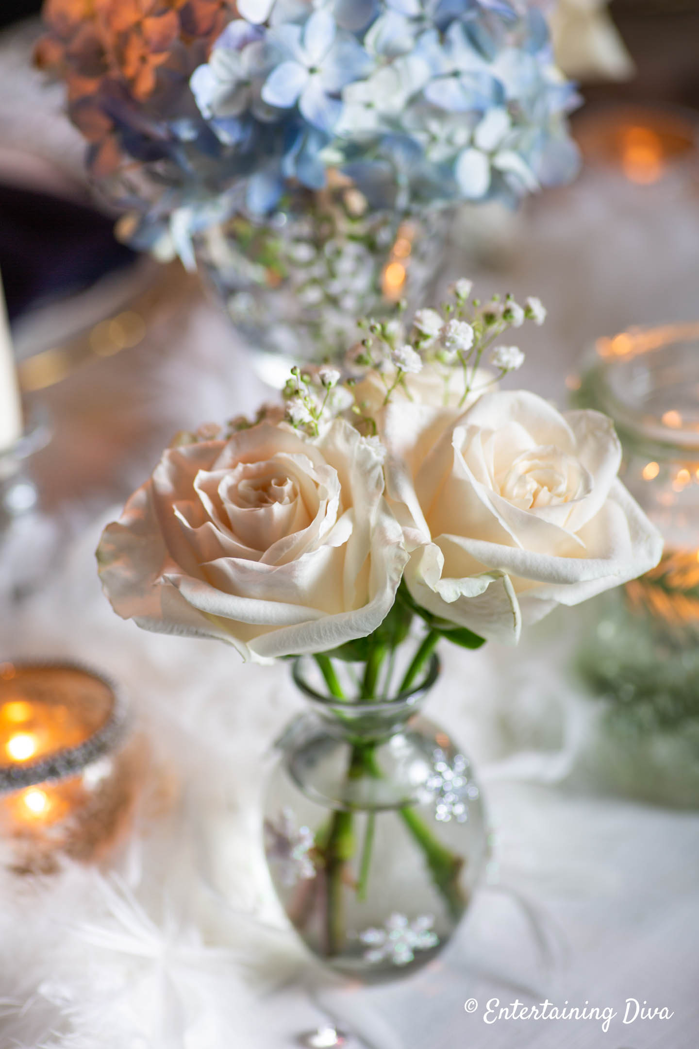 Glass bud vase with snowflakes in winter wonderland centerpiece