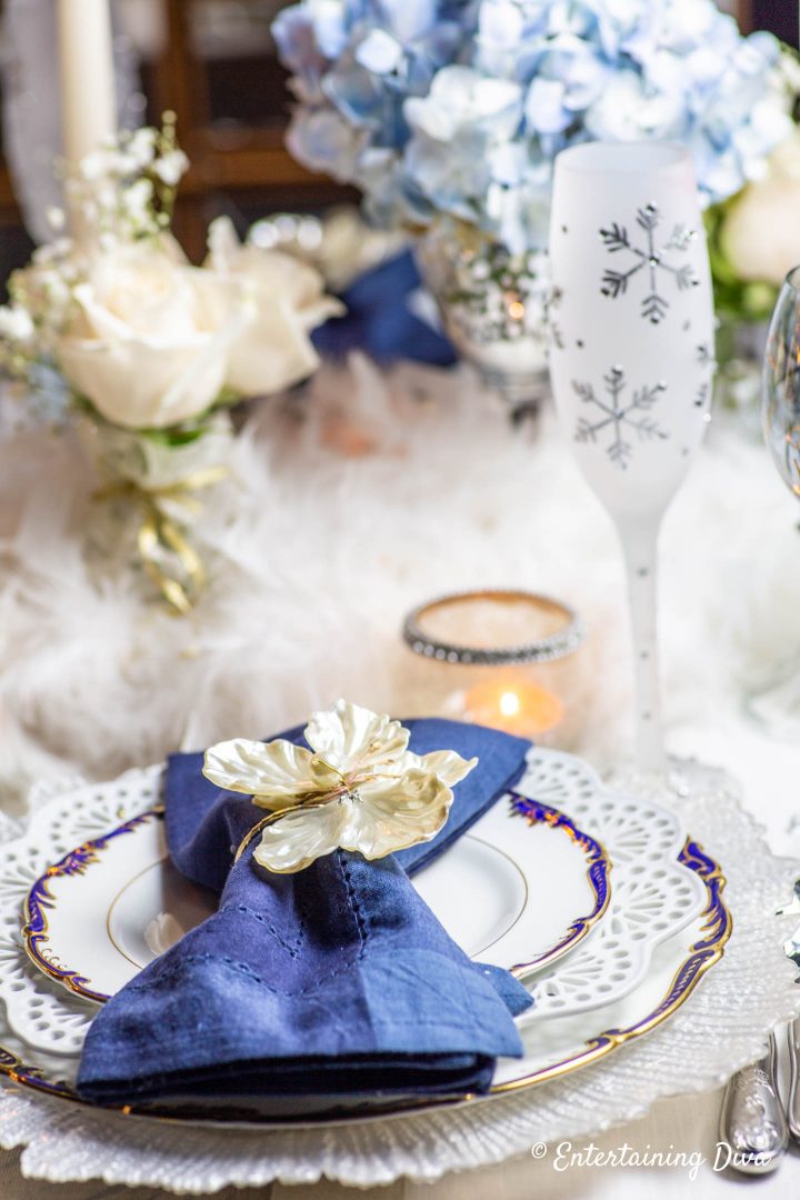 White, blue and gold winter wonderland place setting with snowflake flute