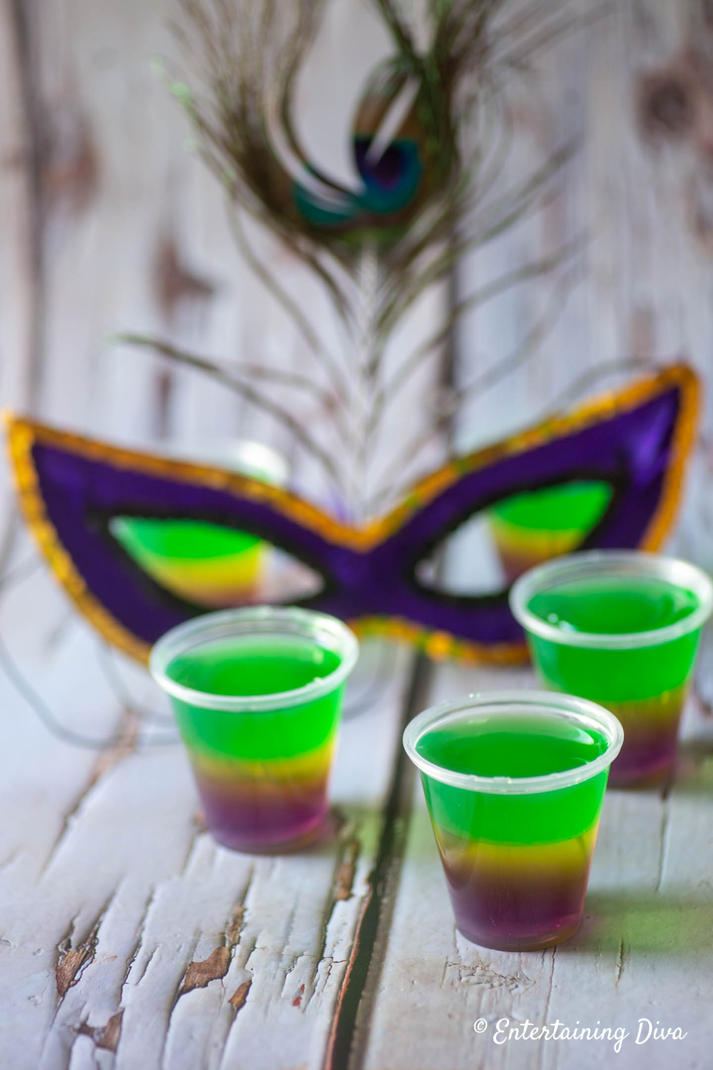 Mardi gras Jello shots with a Mardi Gras mask in the background