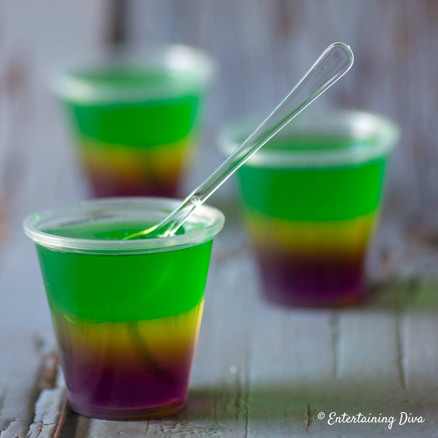 Mardi Gras Jello shots being served with a tasting spoon