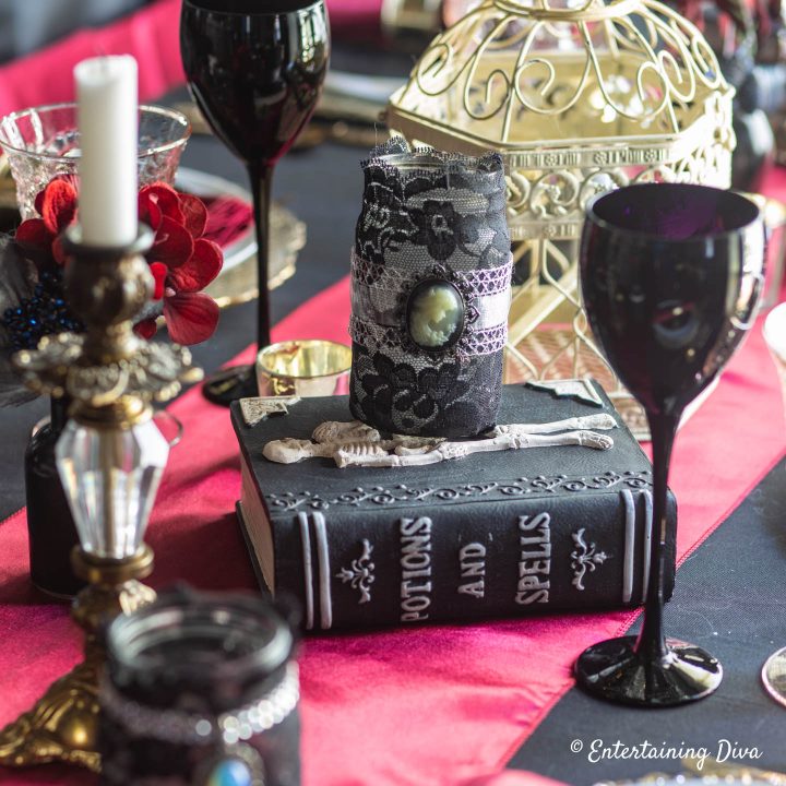Spell book, black wine glasses and candles used for Harry Potter party table decor