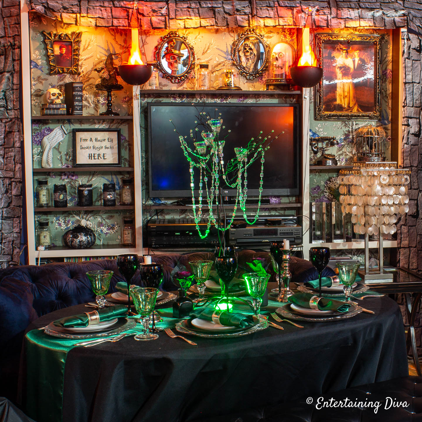 Slytherin table centerpiece made with with candle tree and a green uplight