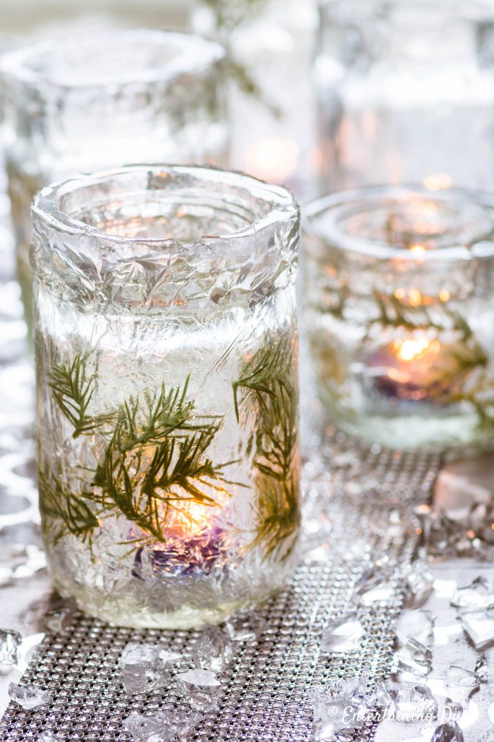 DIY winter wonderland decor: faux ice candle holders with lit candles and faux ice table scatter