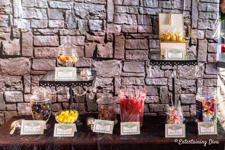 DIY golden snitches displayed in a Honey Dukes candy bar at a Harry Potter party