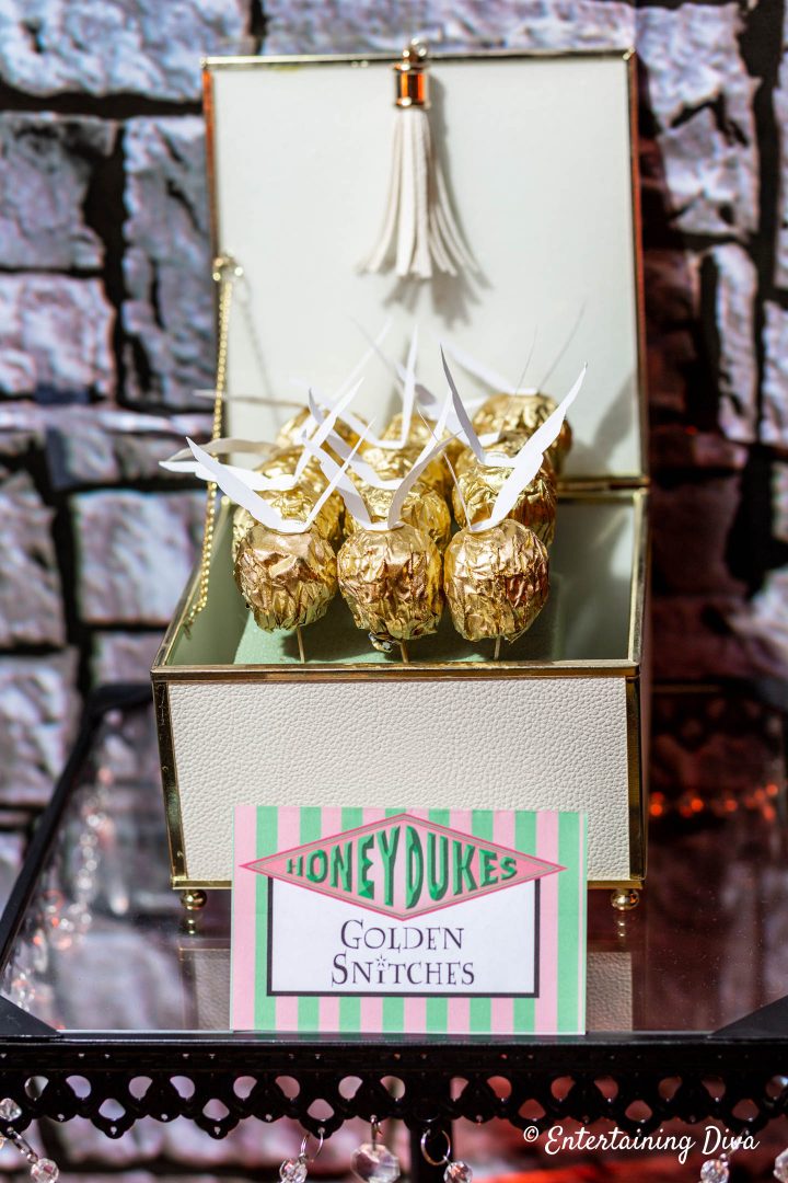 DIY golden snitches displayed in a decorative box