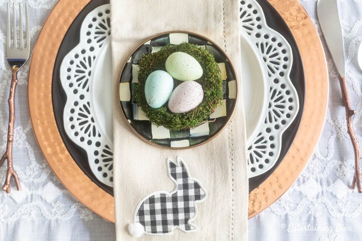 Black, white and copper Easter table place setting with buffalo check Easter bunny on the napkin