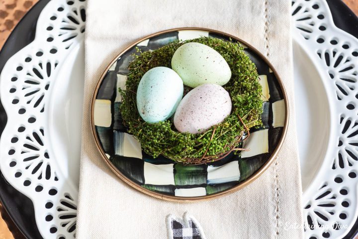 Easter egg nest on top of black and white appetizer plates
