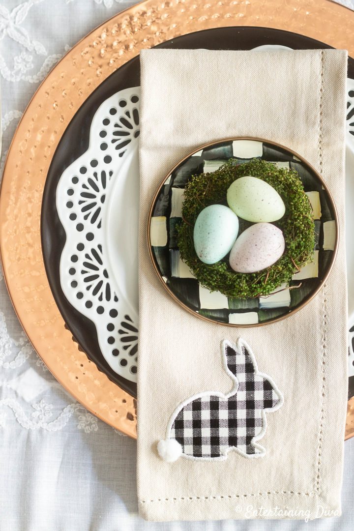 Black, white and copper Easter table setting with Easter egg nest