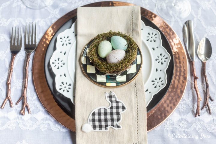 Black, white and copper Easter table setting with copper twig cutlery and buffalo check napkins