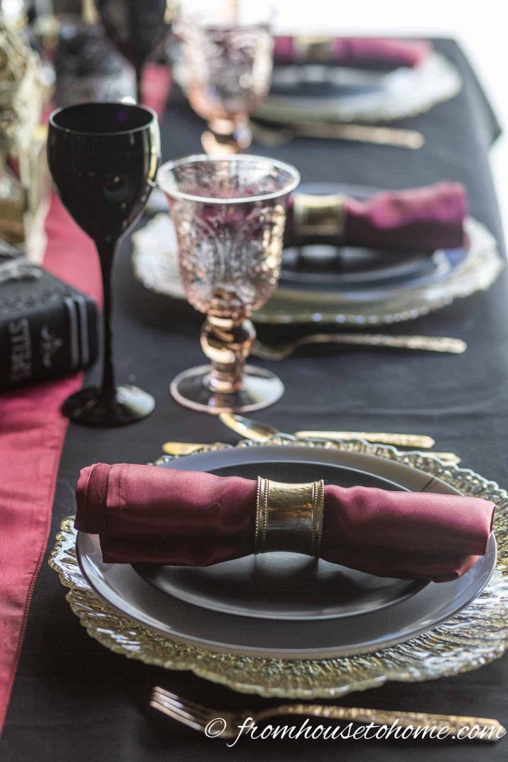 Black, red and gold Halloween place setting with wine glasses