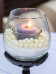 candle in a sand and pearls candle holder