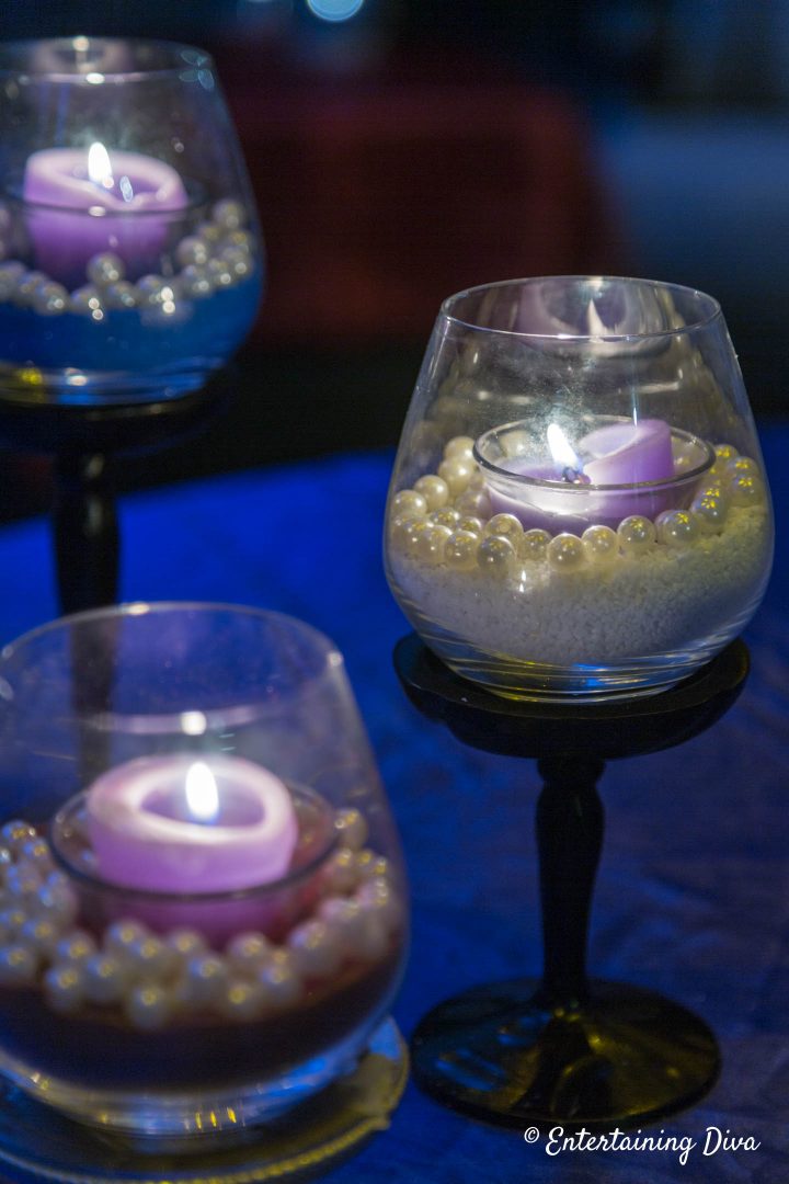 White and blue DIY pearl and sand candle holders at night