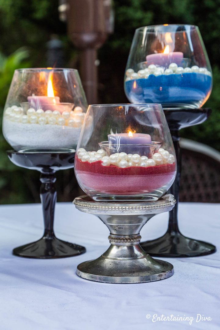 DIY pearl and sand candle holders in red, white and blue used for a 4th of July party