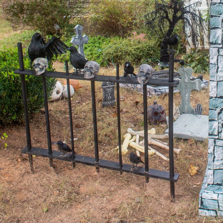 DIY Halloween picket fence in front of a graveyard