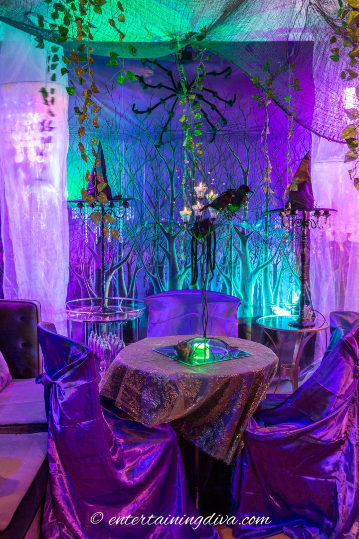 Maleficent party decor with a green lace overlays over a purple tablecloth