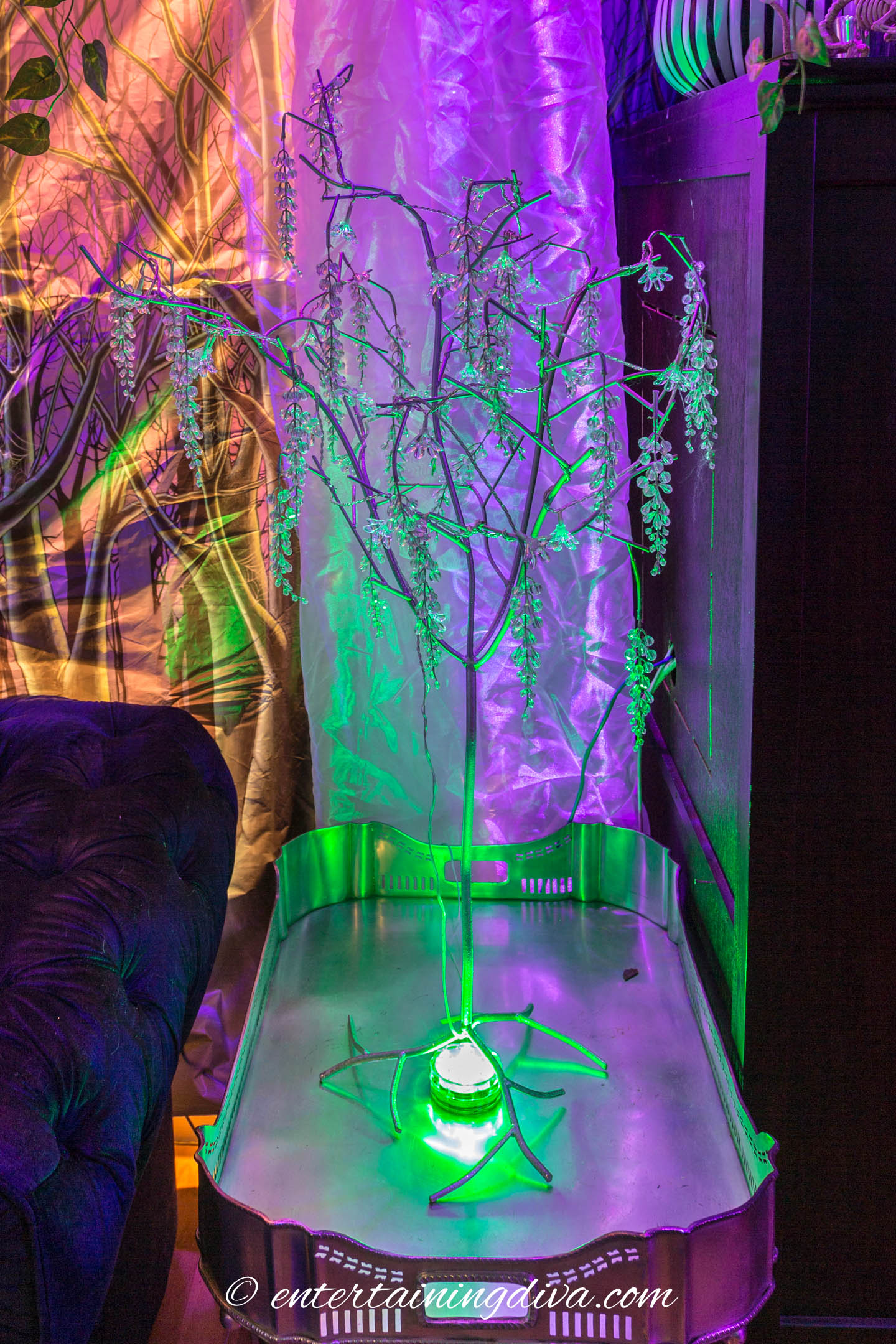 Faux tree lit with a green uplight