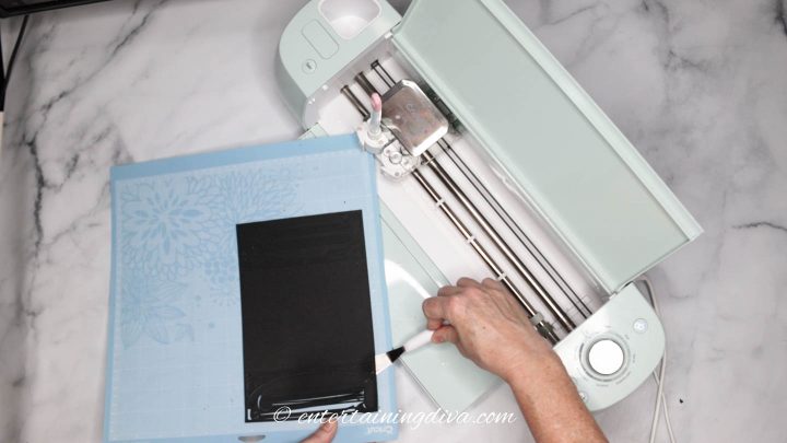 Removing paper from a Cricut mat using a Cricut weeding tool - the spatula