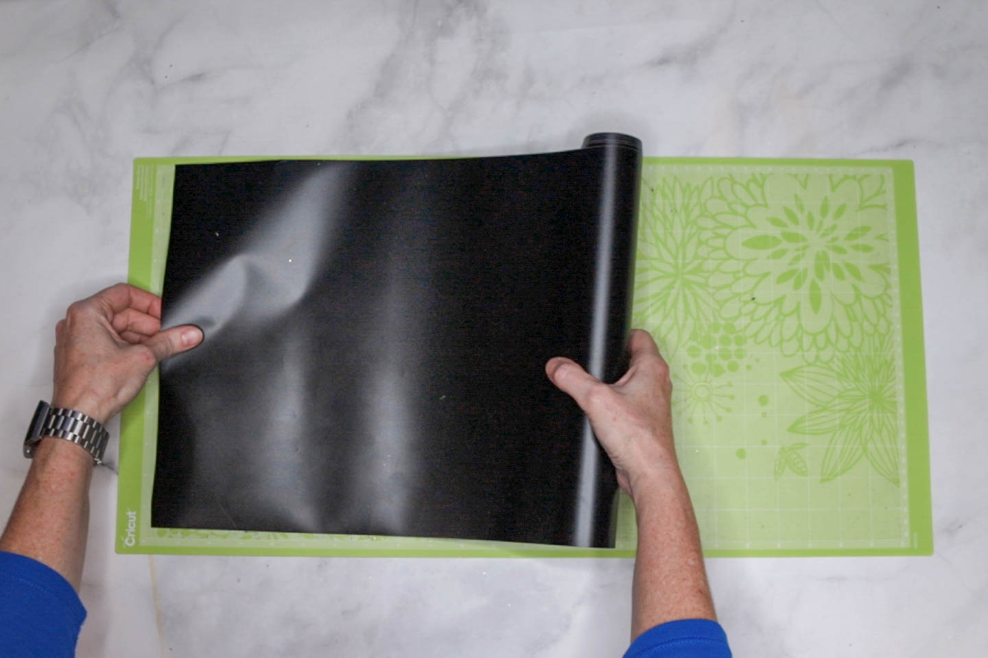 Vinyl being put on long Cricut mat