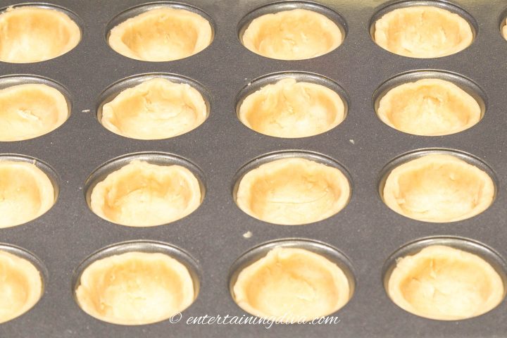 Line the muffin tins with mini tart shells