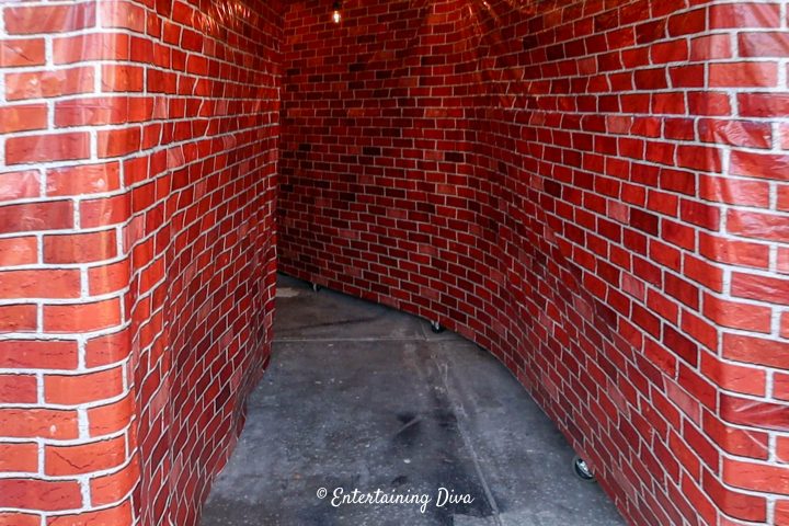 Red brick scene setter walls create an alley in the garage