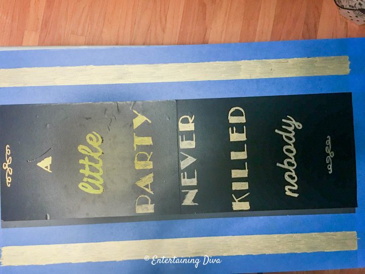 The DIY Gatsby chalkboard sign stencil completely colored in with gold chalk marker