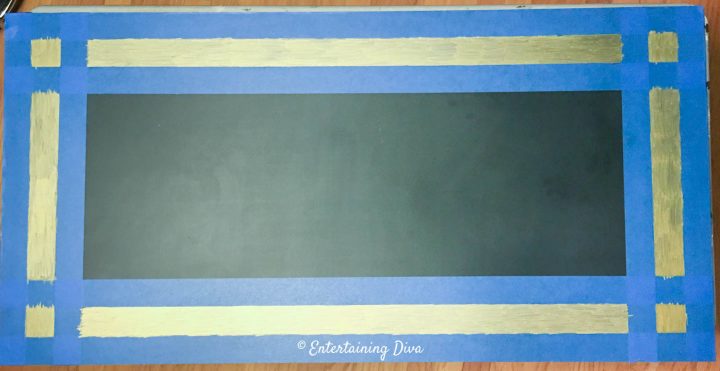 The gold frame for the DIY Gatsby chalkboard sign