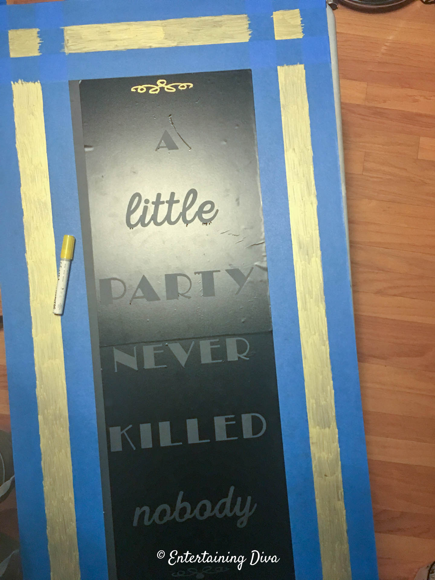 The chalkboard with the vinyl stencil applied to it