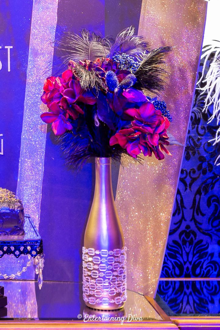 DIY wine bottle centerpiece with a faux floral arrangement