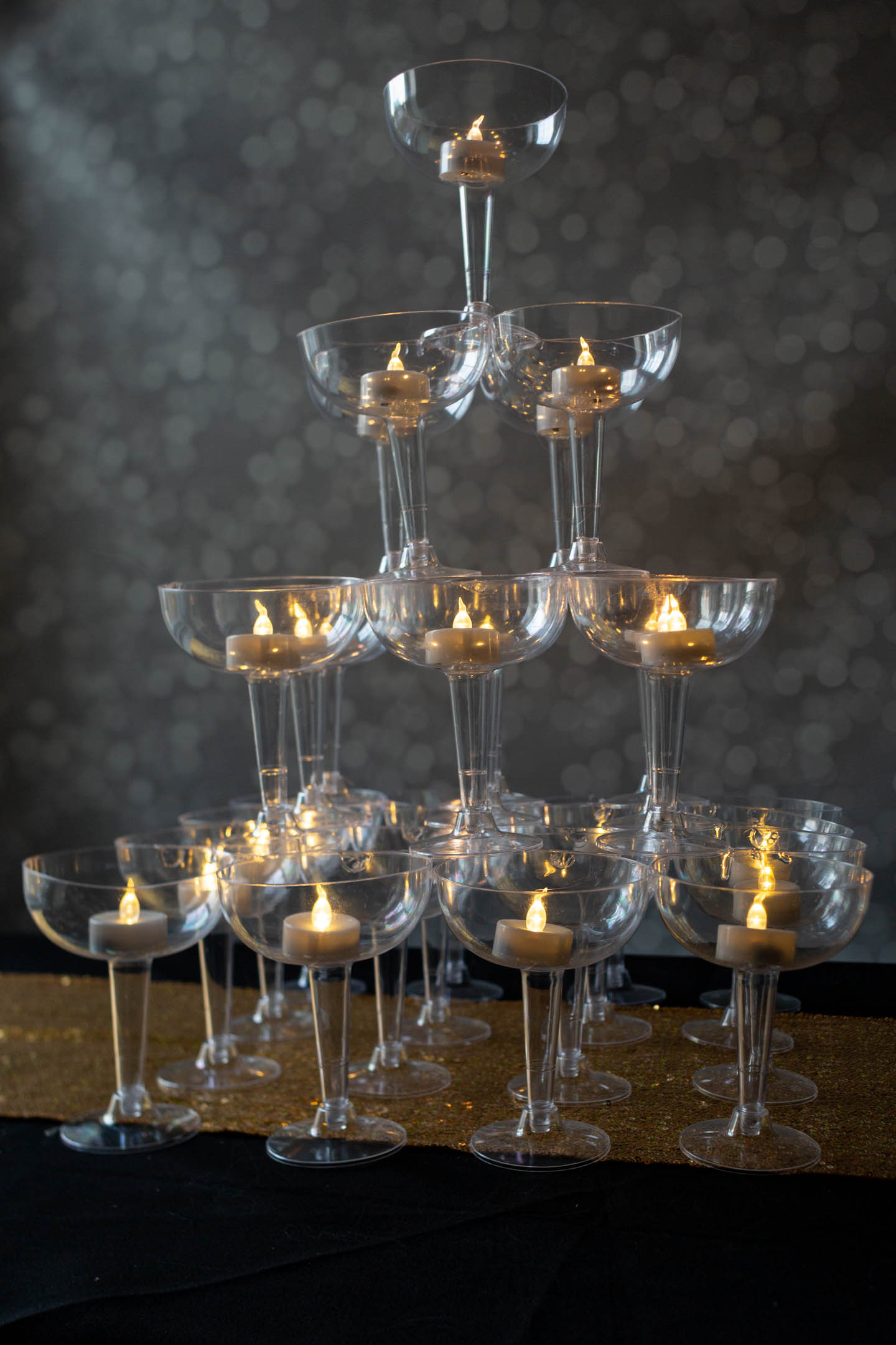 Champagne glass tower with flameless tealight candles for a centerpiece
