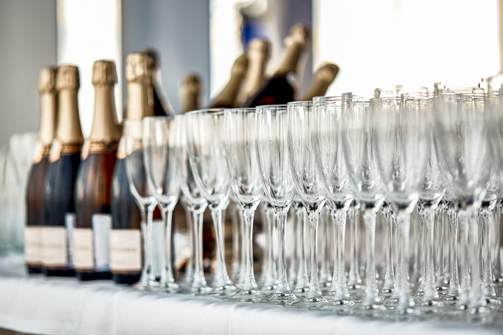 Champagne bottles and glasses at a drink station