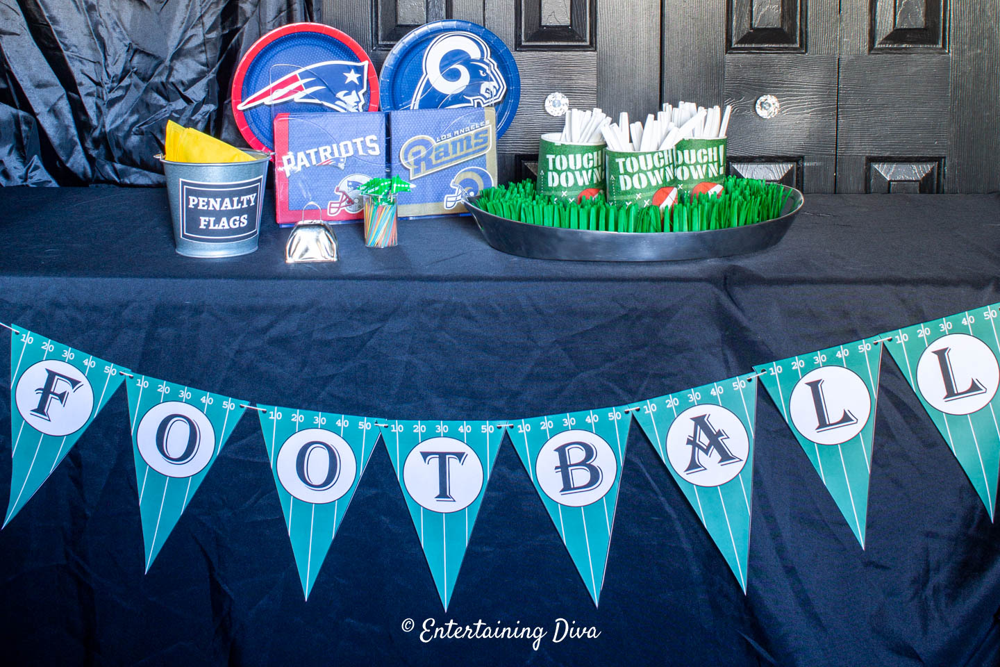 DIY printable Football banner hung on the front of a buffet table