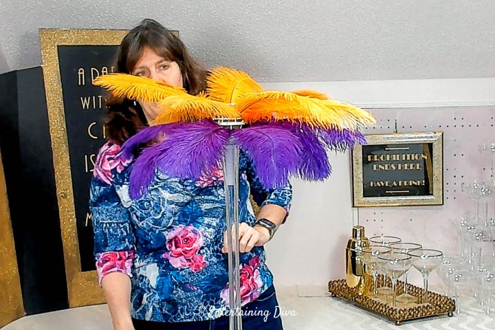 Purple and gold ostrich feathers added to the centerpiece