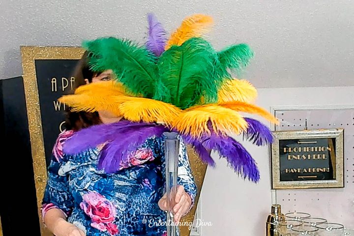 All of the feathers added to the DIY Mardi Gras feather centerpiece