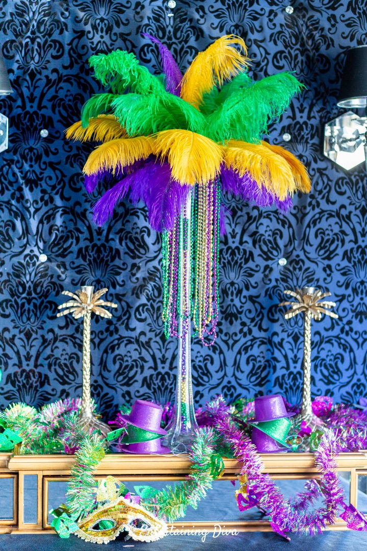 DIY Mardi Gras feather centerpiece with other Mardi Gras party decor