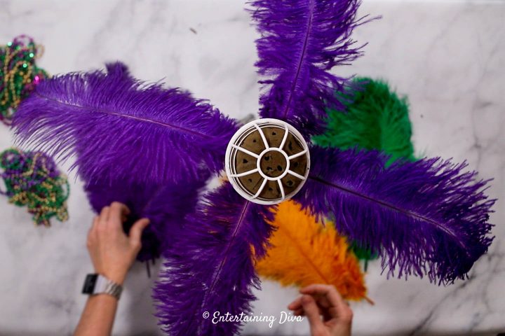 Four purple ostrich feathers added to the centerpiece