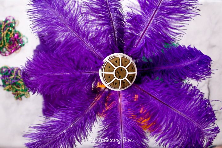 Eight purple feathers in the bottom layer of the Mardi Gras centerpiece