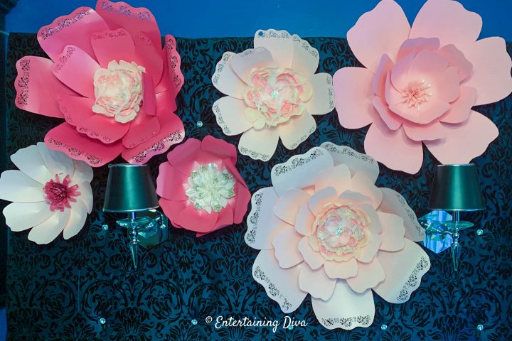 DIY giant paper flowers on an upholstered backdrop