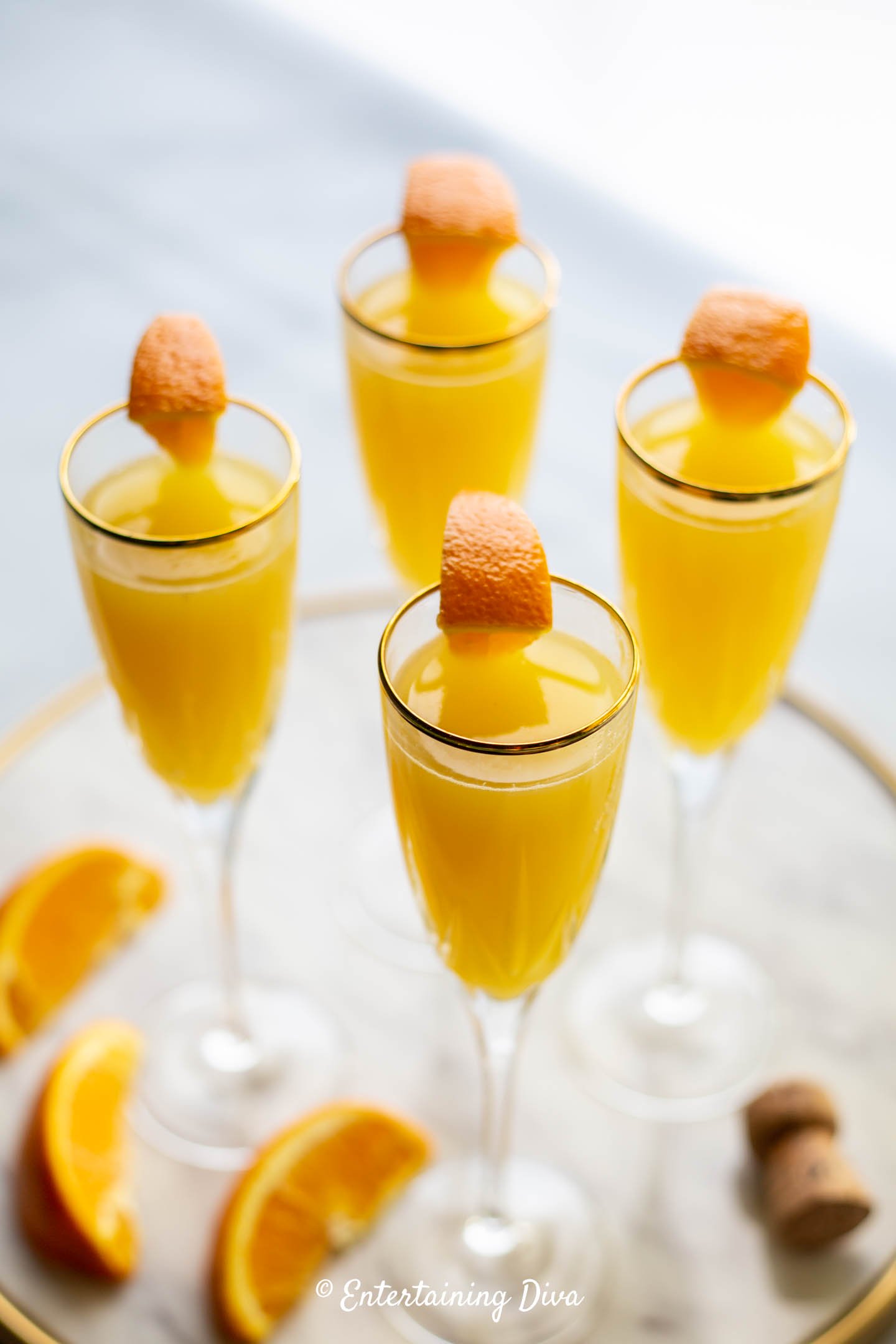 Mimosas with orange slices as garnish