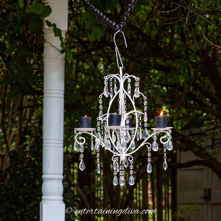White candle chandelier hung from a temporary outdoor light pole
