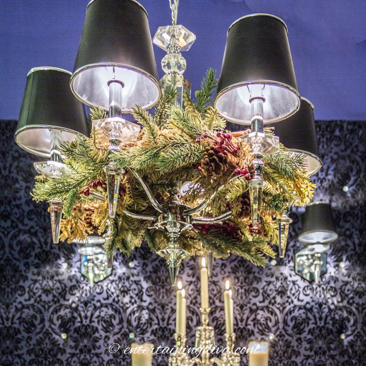 Evergreen Christmas garland hung around a chandelier