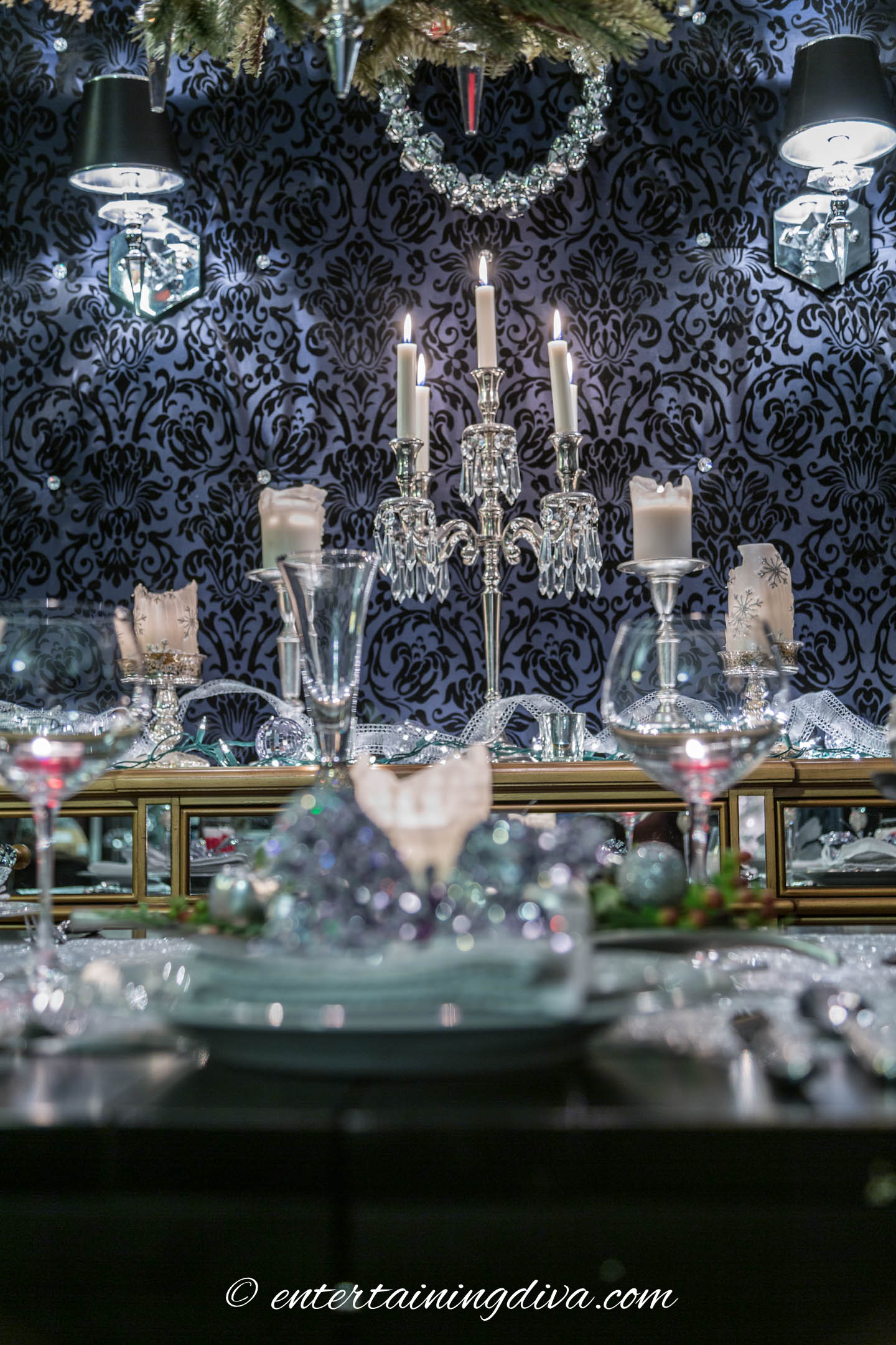 White candles with silver candle holders on a buffet
